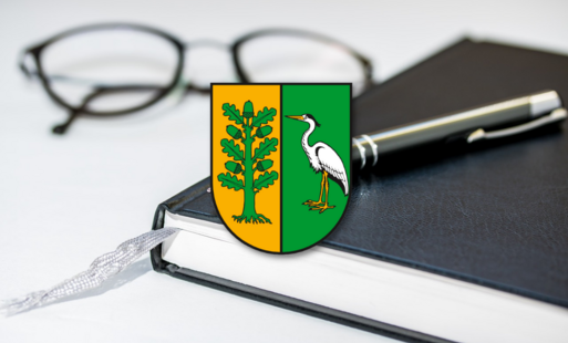 notatnik, okulary i herb gminy